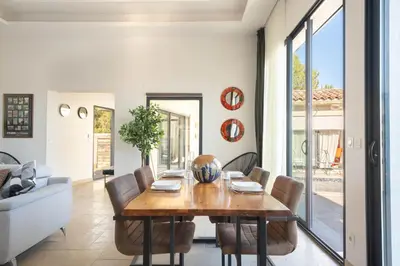 a dining room with a table and chairs at Aria Blue - Spacieuse - Climatisée - Piscine in Lançon-Provence