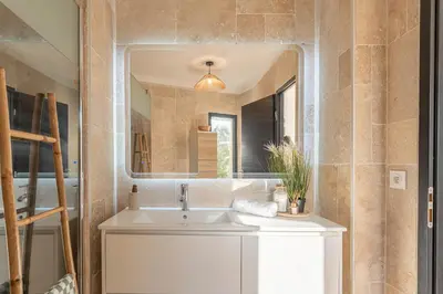 a bathroom with a sink and a mirror at Aria Blue - Spacieuse - Climatisée - Piscine in Lançon-Provence