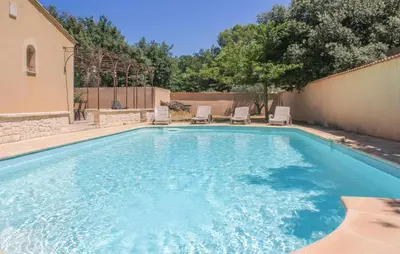 a swimming pool with two lawn chairs at Awesome Home In Saint Didier in Saint-Didier