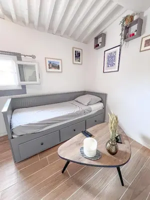 a bedroom with a bed and a coffee table at Studio coeur de ville, rue Papassaudi in Aix-en-Provence