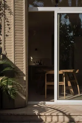 an open sliding glass door with a table outside at Maison Rosalie in Carpentras