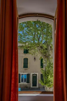 a clock tower on top of a building at Maison de village au cœur d'Eyguières Alpilles in Eyguières