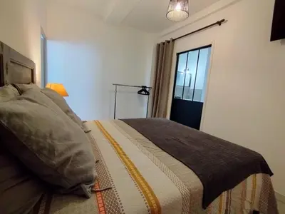 a bedroom with a bed and a window at Joli appartement centre village au calme in Châteaurenard