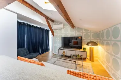 a bedroom with a large bed and a television at Design & Cozy, 10 meters from Cours Mirabeau, AC in Aix-en-Provence