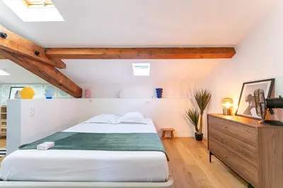 a bedroom with a bed and a wooden dresser at Design & Cozy, 10 meters from Cours Mirabeau, AC in Aix-en-Provence