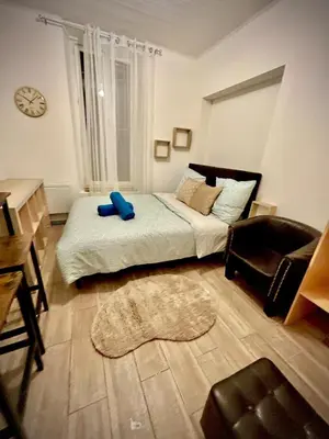 a bedroom with a bed and a chair and a table at appartement,au luberon in Cavaillon