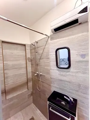 a bathroom with a shower and a sink and a mirror at appartement,au luberon in Cavaillon