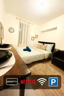 a bedroom with a bed and a desk with a tv at appartement,au luberon in Cavaillon