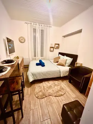 a bedroom with a bed and a desk and a chair at appartement,au luberon in Cavaillon