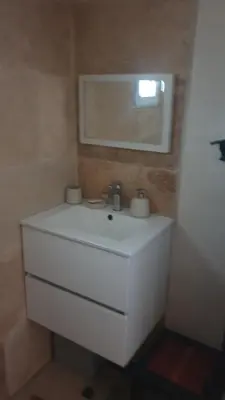 a bathroom with a white sink and a mirror at Petite maison sur Apt in Apt