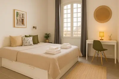 a bedroom with a large bed with towels on it at Cozy et elegant studio Aix en Provence centre in Aix-en-Provence