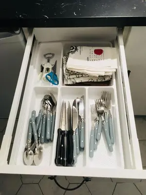 a drawer filled with utensils in a cabinet at Cocon cosy et calme au coeur du centre historique in Aix-en-Provence