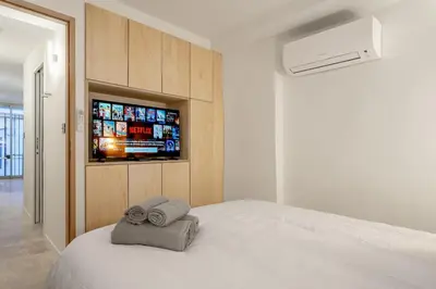 a bedroom with a bed with two towels on it at Logement elegant avec patio prive et climatisation in Aix-en-Provence