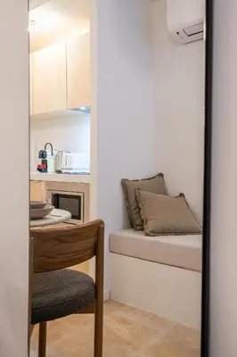 a room with a bed and a table with a chair at Logement elegant avec patio prive et climatisation in Aix-en-Provence