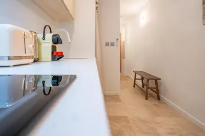 a kitchen counter with a sink and a table at Logement elegant avec patio prive et climatisation in Aix-en-Provence