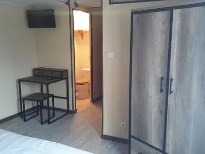 a room with a door and a table and a bed at Les Granges in Villars