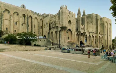 a large building with people walking in front of it at Maison De Charme in Jonquerettes