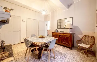 a dining room with a table and chairs at Maison De Charme in Jonquerettes