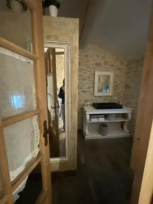 a person is standing in a bathroom with a mirror at Domaine de la barbeirasse in Céreste
