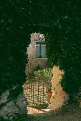 a gate in front of a building with a window at Domaine de la barbeirasse in Céreste