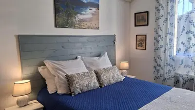 a bedroom with a blue bed with two pillows at Villa Figlio en Provence avec petite piscine in Châteaurenard