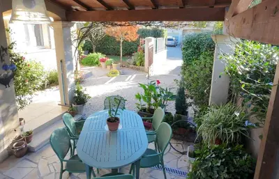 a blue table and chairs on a patio at Villa Figlio en Provence avec petite piscine in Châteaurenard