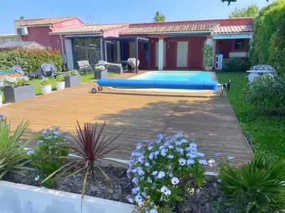 a backyard with a wooden deck and a swimming pool at Tiny house Cécile en Avignon in Avignon