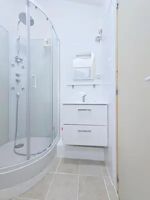 a white bathroom with a shower and a sink at Tiny house Cécile en Avignon in Avignon