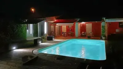 a swimming pool in a yard at night at Tiny house Cécile en Avignon in Avignon