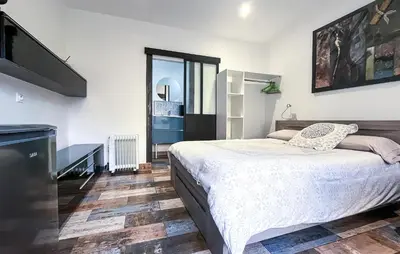 a bedroom with a large bed and a staircase at Cozy Home In Miramas With Outdoor Swimming Pool in Miramas