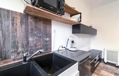 a kitchen with a sink and a microwave at Cozy Home In Miramas With Outdoor Swimming Pool in Miramas