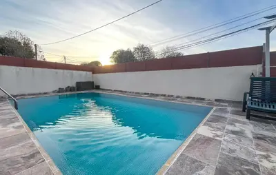 a swimming pool with blue water in a backyard at Cozy Home In Miramas With Outdoor Swimming Pool in Miramas