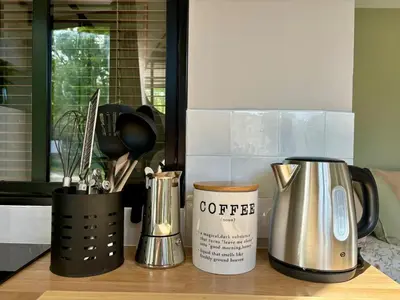 a kitchen counter with coffee appliances on a counter top at Studio tout confort dans la campagne aixoise in Le Puy-Sainte-Réparade