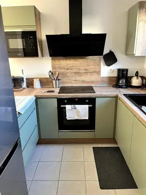 a kitchen with a stove and a sink at Charming house, Lubéron, near golf and wineries in Pierrevert
