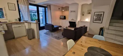 a living room with a couch and a table at Charming village house in Éguilles