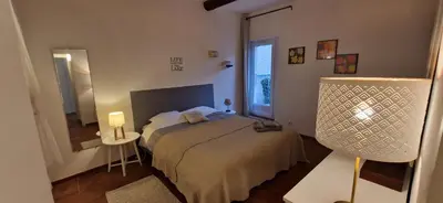 a small bedroom with a bed and a window at Charming village house in Éguilles