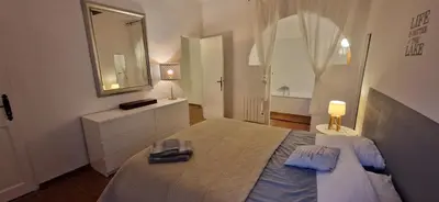 a bedroom with a large bed and a mirror at Charming village house in Éguilles