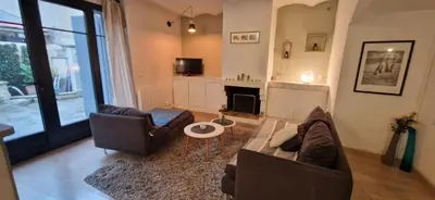 a living room with two couches and a fireplace at Charming village house in Éguilles
