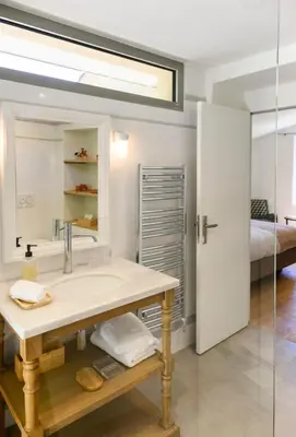a bathroom with a sink and a bed at Le Hameau des Sources Lourmarin Luberon in Lourmarin