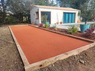 an orange concrete driveway with a house in the background at mas alpilles in Eyguières