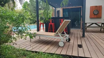 a chair on a deck next to a pool at mas alpilles in Eyguières