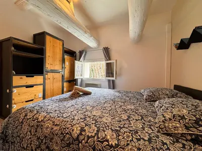 a bedroom with a bed and a dresser at Le Breizh'Aix - Joli duplex au cœur du centre ville d'Aix-en-Provence avec jardin in Aix-en-Provence