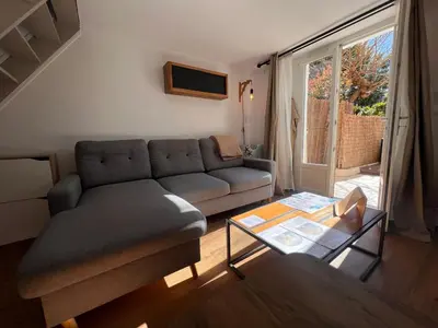 a large bed in a room with a large window at Le Breizh'Aix - Joli duplex au cœur du centre ville d'Aix-en-Provence avec jardin in Aix-en-Provence