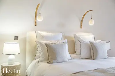 a bedroom with a bed with white pillows at Domaine Arterra I Parc privé, Piscine & Tennis in Lauris
