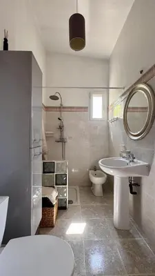 a bathroom with a sink and a toilet and a mirror at Studio en Provence in Cheval-Blanc