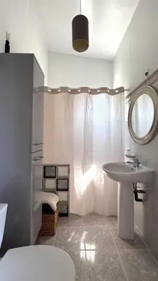 a white bathroom with a sink and a mirror at Studio en Provence in Cheval-Blanc