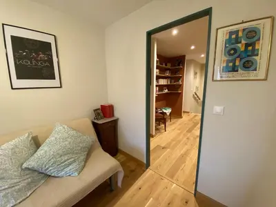 a living room with a couch and a mirror at Casa Poli, maison de village avec terrasse in Eyguières