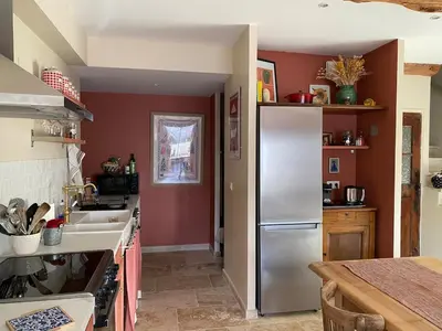 a kitchen with a stainless steel refrigerator and a sink at Casa Poli, maison de village avec terrasse in Eyguières
