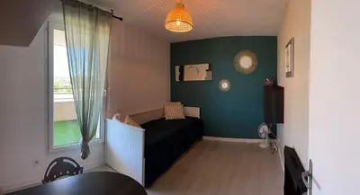 a small room with a bed and a window at Charmant appartement hotel calme à Aix en Provence in Aix-en-Provence
