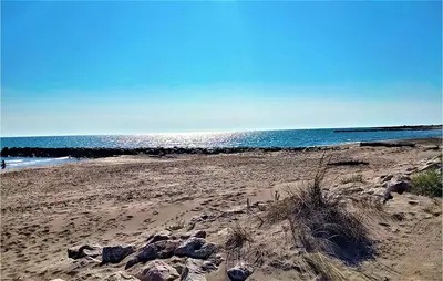 a beach with rocks and the ocean in the background at Awesome Home In Miramas With Swimming Pool in Miramas